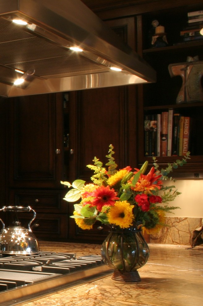 Example of a large transitional u-shaped terra-cotta tile open concept kitchen design with a farmhouse sink, furniture-like cabinets, dark wood cabinets, granite countertops, stone slab backsplash, stainless steel appliances, white walls and an island