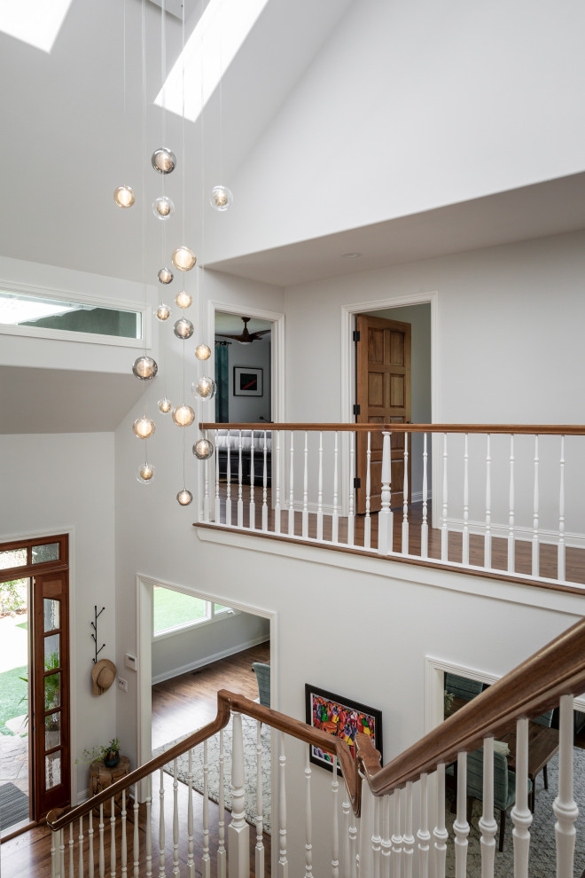 Front door - large transitional medium tone wood floor and brown floor front door idea in San Francisco with white walls and a medium wood front door