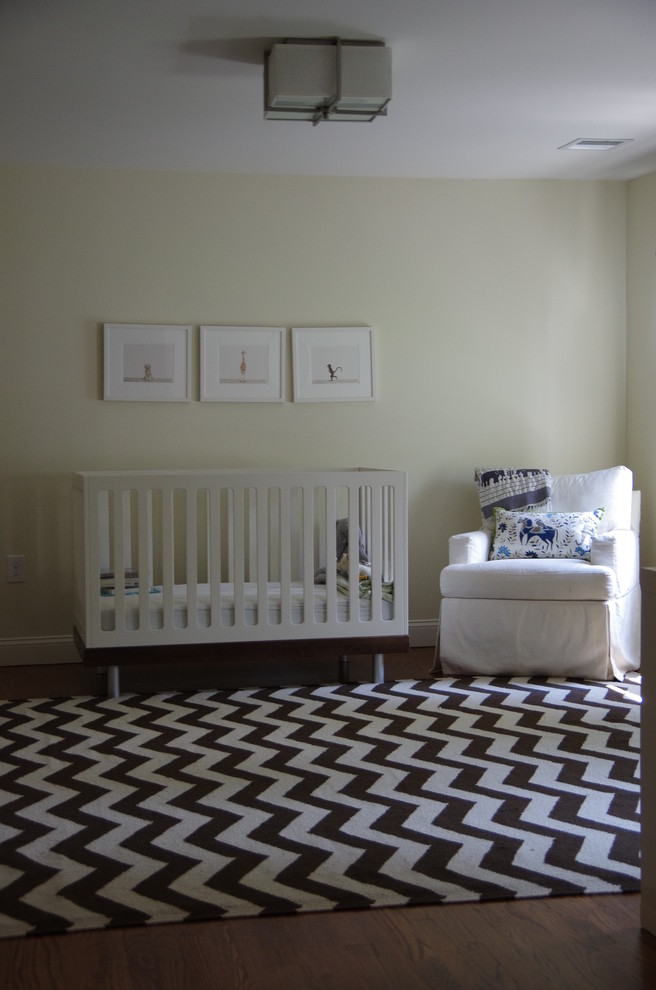 Inspiration for a mid-sized transitional gender-neutral nursery in Boston with beige walls, dark hardwood floors and brown floor.