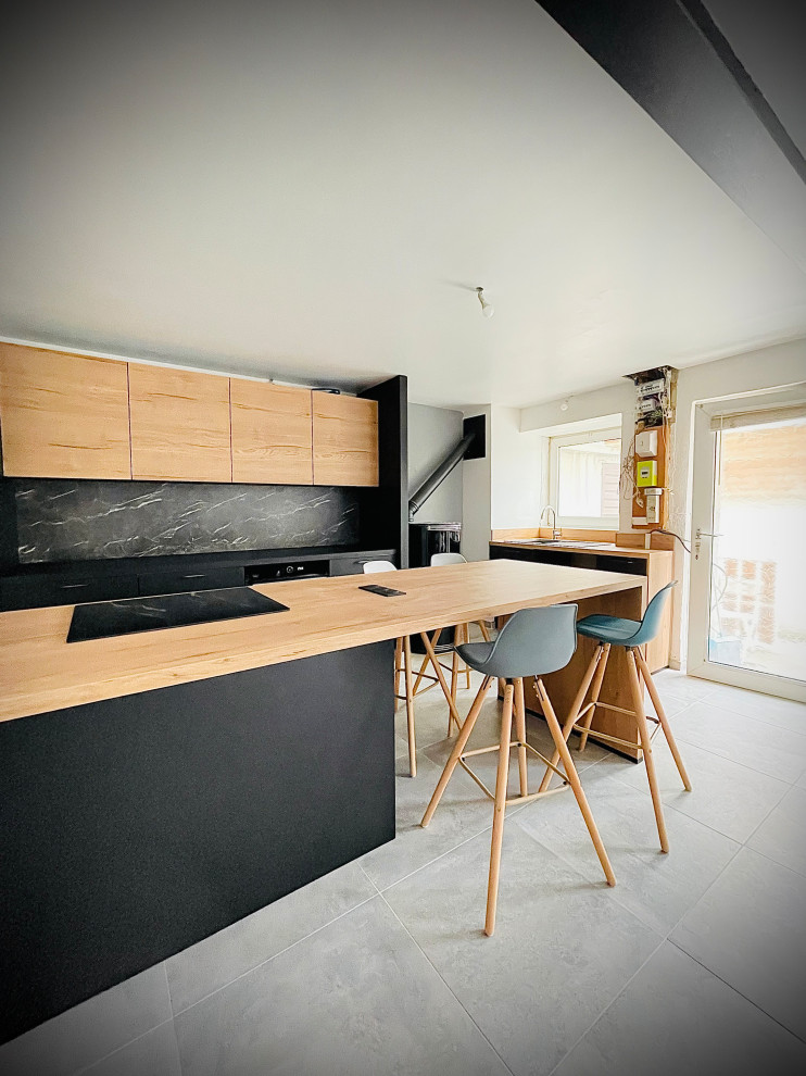 Photo of a large contemporary galley open plan kitchen with a submerged sink, black cabinets, laminate countertops, black splashback, marble splashback, integrated appliances, ceramic flooring, an island, grey floors and black worktops.