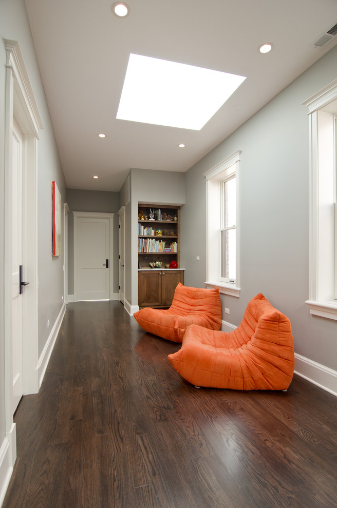 Photo of a transitional hallway in Chicago with grey walls and dark hardwood floors.