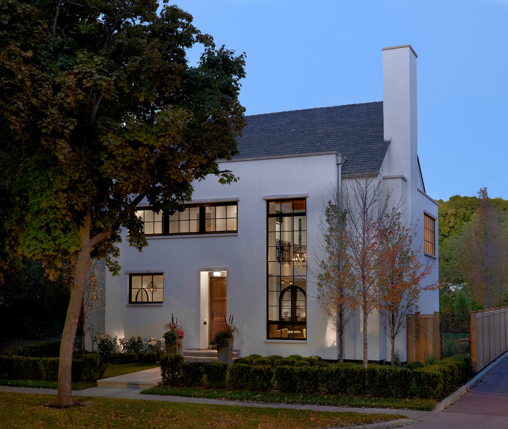 Design ideas for a mid-sized eclectic two-storey stucco white exterior in Chicago.