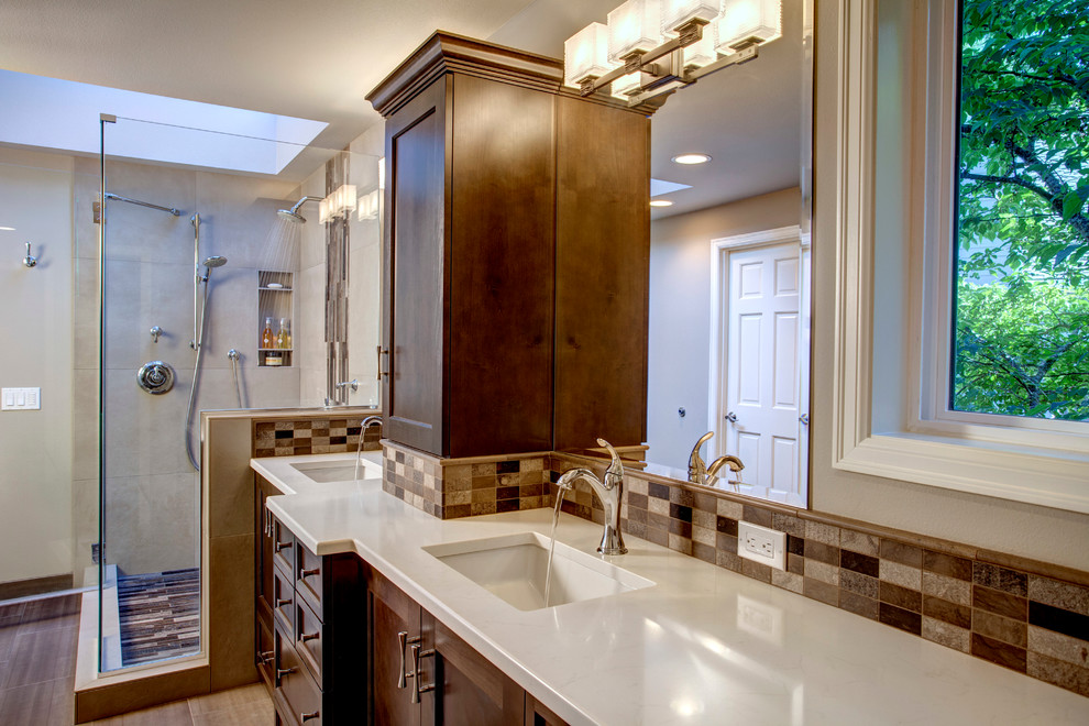 Large traditional master bathroom in Seattle with an undermount sink, shaker cabinets, dark wood cabinets, engineered quartz benchtops, a corner shower, a two-piece toilet, brown tile, stone tile, grey walls and porcelain floors.