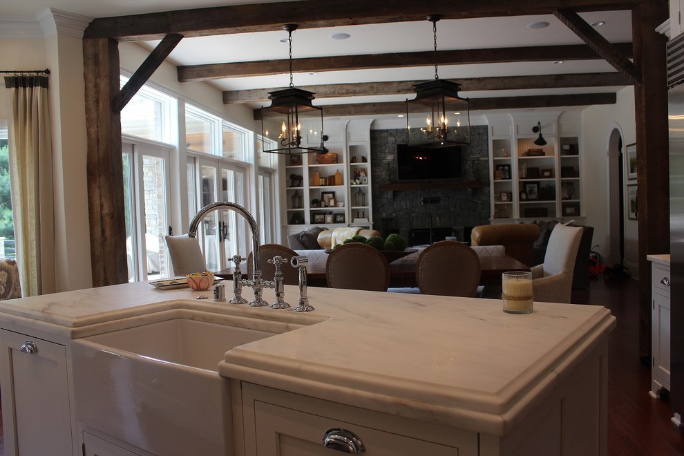 Inspiration for a large traditional l-shaped eat-in kitchen in Other with a farmhouse sink, shaker cabinets, white cabinets, marble benchtops, grey splashback, stone tile splashback, stainless steel appliances, dark hardwood floors and with island.