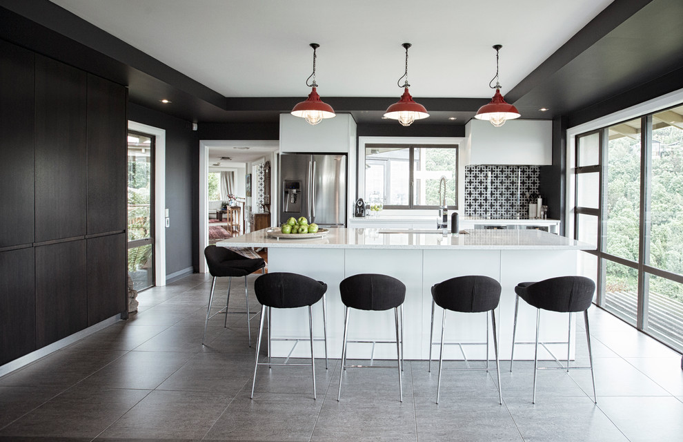 Contemporary separate kitchen in Christchurch with an undermount sink, flat-panel cabinets, multi-coloured splashback, stainless steel appliances and with island.