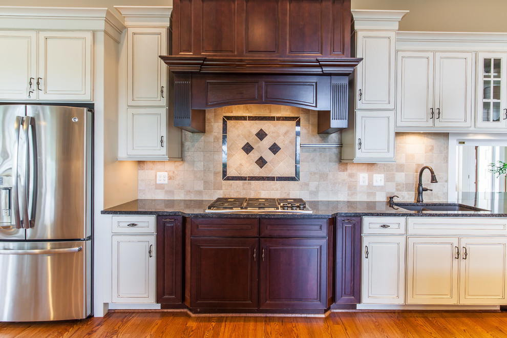 Inspiration for a huge transitional medium tone wood floor eat-in kitchen remodel in DC Metro with raised-panel cabinets, granite countertops, stainless steel appliances and an island