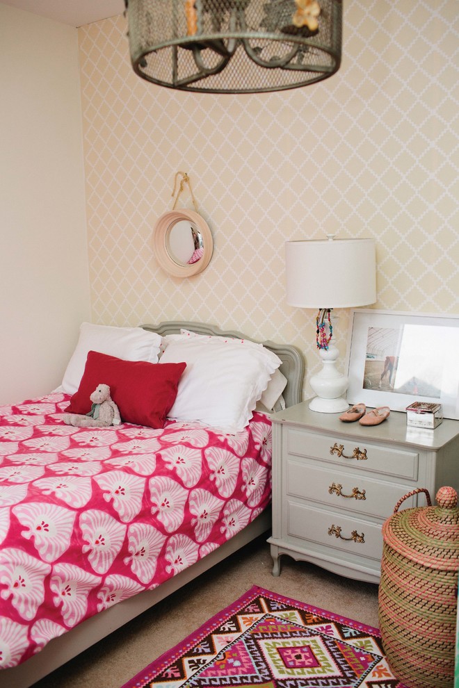 This is an example of a traditional kids' bedroom for kids 4-10 years old and girls in Birmingham with beige walls and carpet.