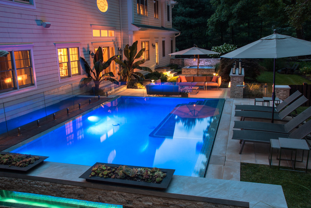Design ideas for a mid-sized modern backyard rectangular infinity pool in New York.