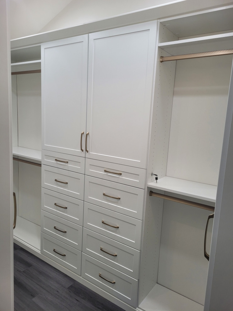 Inspiration for a mid-sized traditional gender-neutral walk-in wardrobe in New York with raised-panel cabinets, white cabinets, vinyl floors and grey floor.