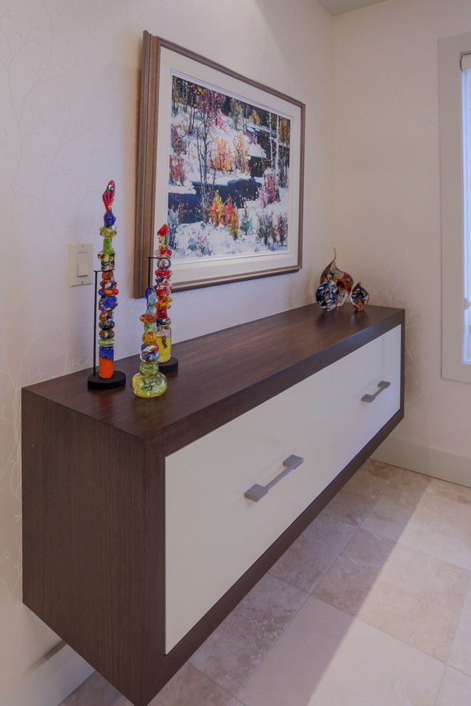 Design ideas for a mid-sized contemporary entryway in Calgary with multi-coloured walls and travertine floors.