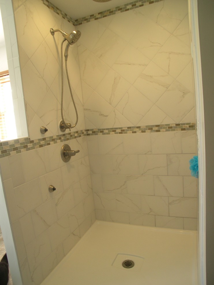 Freestanding bathtub - mid-sized transitional master white tile and porcelain tile porcelain tile freestanding bathtub idea with an undermount sink, shaker cabinets, white cabinets, marble countertops, a two-piece toilet and gray walls