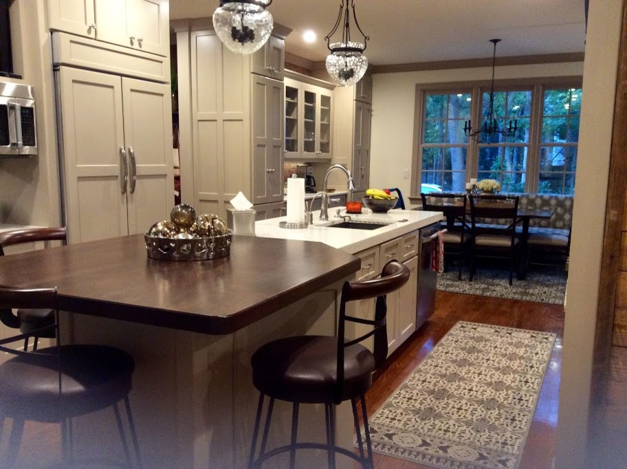 Design ideas for a mid-sized transitional galley eat-in kitchen in Raleigh with an undermount sink, shaker cabinets, beige cabinets, quartz benchtops, red splashback, brick splashback, stainless steel appliances, dark hardwood floors and with island.