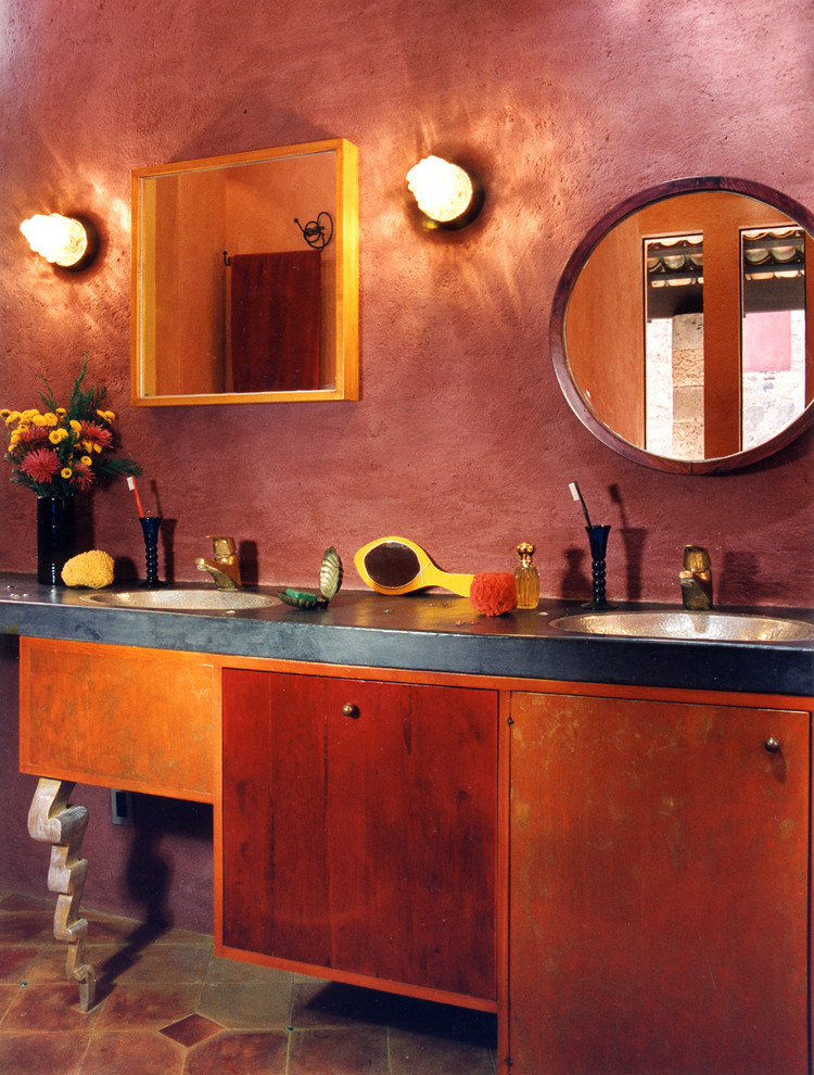 Design ideas for a small eclectic master bathroom with a drop-in sink, flat-panel cabinets, concrete benchtops, an open shower, a one-piece toilet, red tile, terra-cotta floors and red walls.