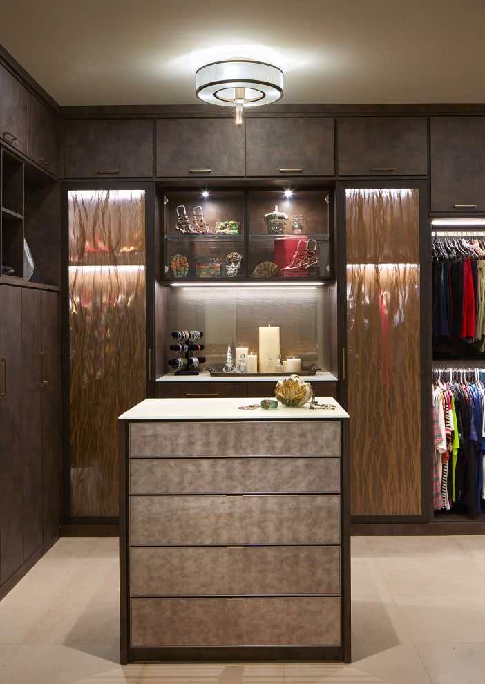 Photo of a large contemporary gender-neutral walk-in wardrobe in Phoenix with flat-panel cabinets, brown cabinets, porcelain floors and beige floor.