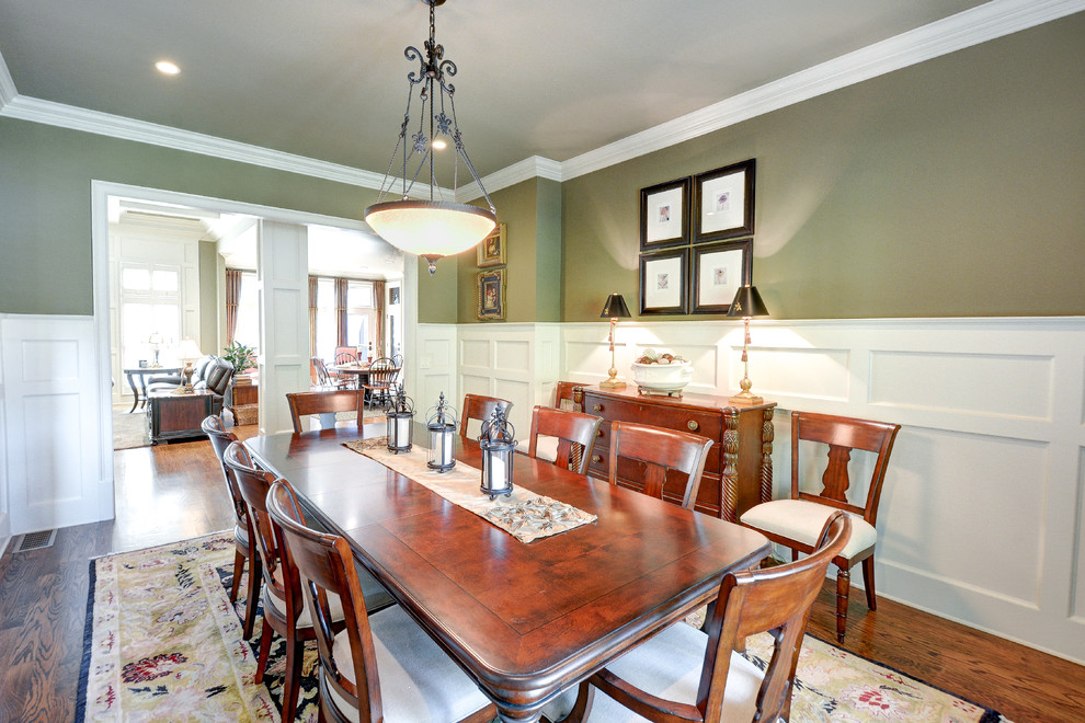 Inspiration for a mid-sized traditional separate dining room in Atlanta with green walls, medium hardwood floors and no fireplace.