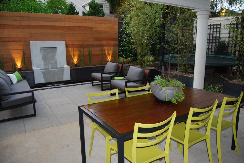 Small contemporary backyard partial sun garden in Portland with a water feature and concrete pavers.
