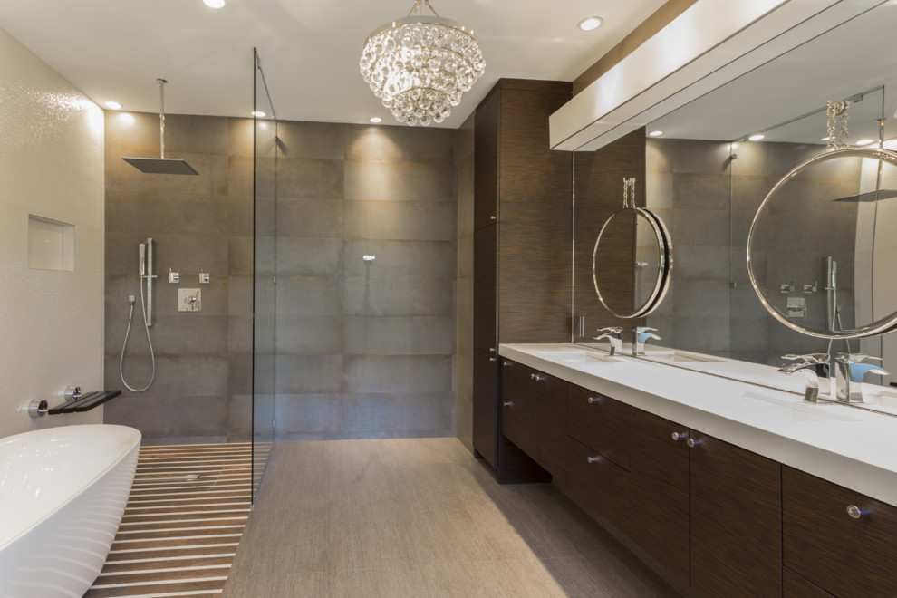 Design ideas for an expansive contemporary master bathroom in Houston with an undermount sink, dark wood cabinets, a freestanding tub, a shower/bathtub combo, gray tile, porcelain tile, multi-coloured walls, quartzite benchtops, a wall-mount toilet, porcelain floors and flat-panel cabinets.