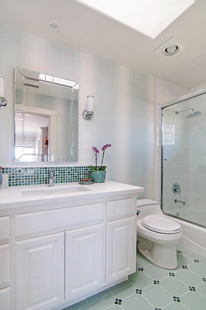 Design ideas for a large transitional master bathroom in San Diego with raised-panel cabinets, white cabinets, an undermount sink, engineered quartz benchtops, a freestanding tub, a double shower, a one-piece toilet, white tile, stone tile, white walls and limestone floors.
