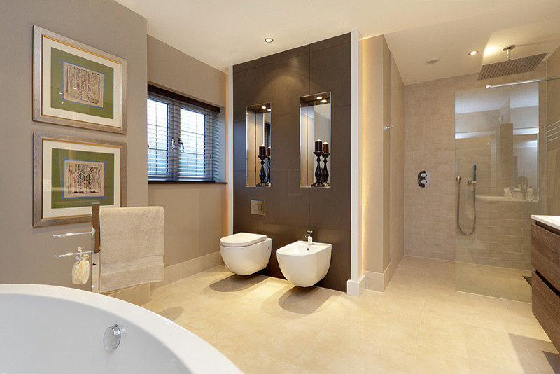 Design ideas for an expansive modern master bathroom in London with a freestanding tub, an alcove shower, a wall-mount toilet, beige tile and porcelain floors.