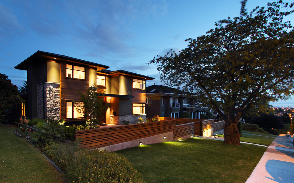 Inspiration for a mid-sized contemporary two-storey brick grey house exterior in Vancouver with a flat roof.