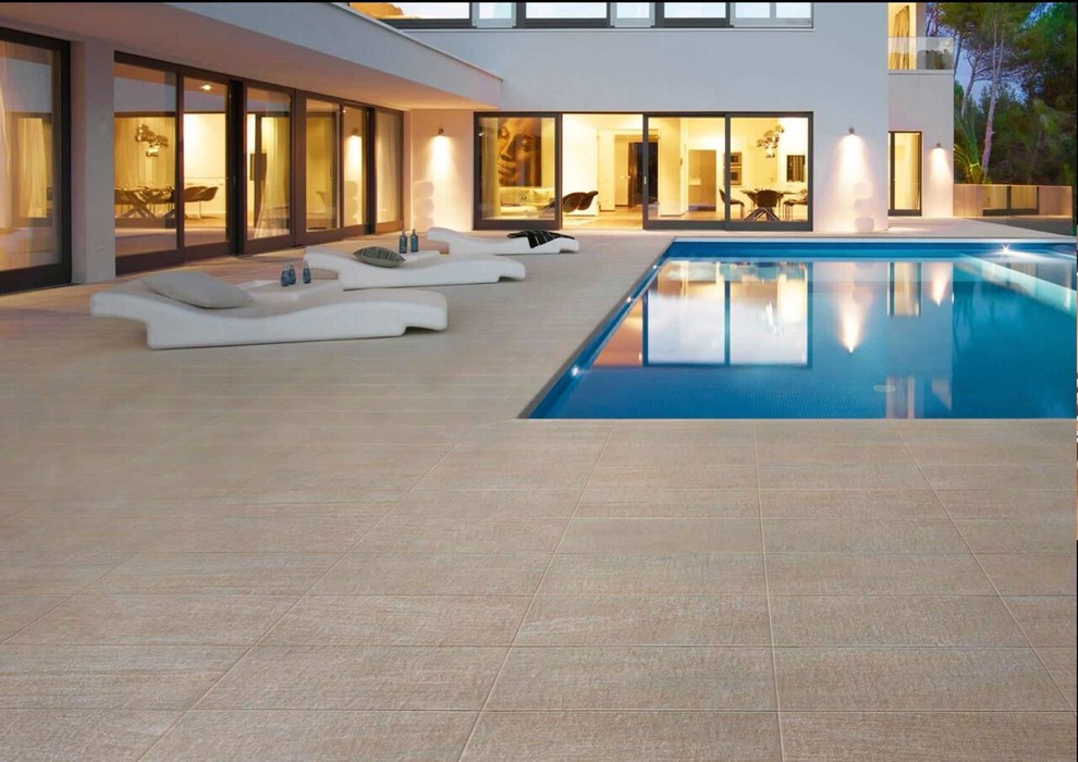 Inspiration for a large contemporary backyard rectangular lap pool in Sydney with tile.