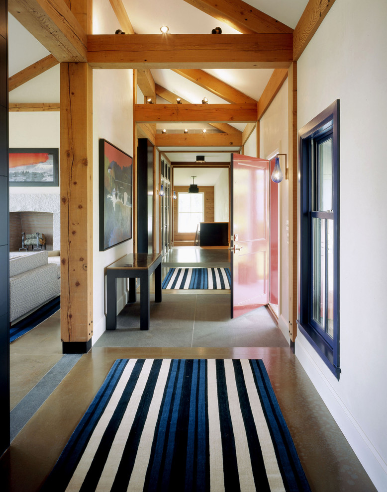 Country entryway in Boston with concrete floors, a single front door and a red front door.