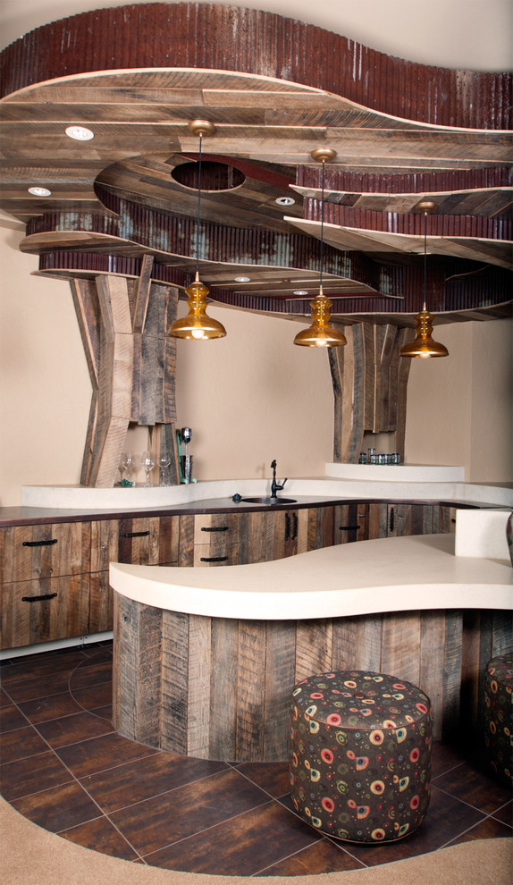 Photo of a transitional u-shaped seated home bar in Denver with an integrated sink, flat-panel cabinets, distressed cabinets, copper benchtops and porcelain floors.