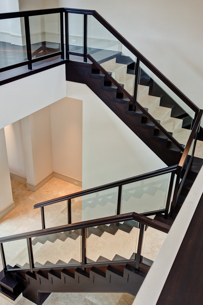 This is an example of a mid-sized modern wood u-shaped staircase in Miami with wood risers.
