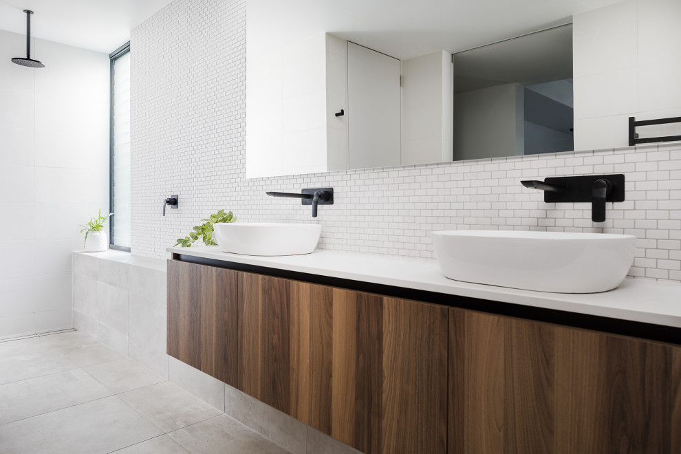 Design ideas for a modern bathroom in Perth with flat-panel cabinets, dark wood cabinets, white tile, mosaic tile, a vessel sink, grey floor and white benchtops.