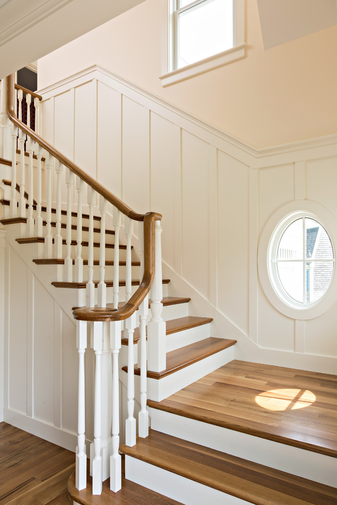 Design ideas for a mid-sized transitional wood l-shaped staircase in New York with painted wood risers and wood railing.
