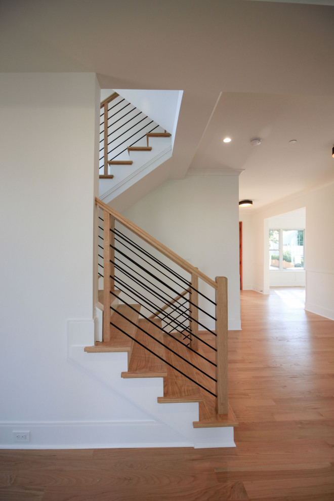 Design ideas for a mid-sized contemporary wood floating staircase in DC Metro with painted wood risers, mixed railing and planked wall panelling.