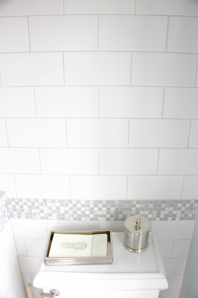 Inspiration for a small transitional master white tile and ceramic tile ceramic tile corner shower remodel with shaker cabinets, dark wood cabinets, a two-piece toilet, blue walls, an undermount sink and quartz countertops