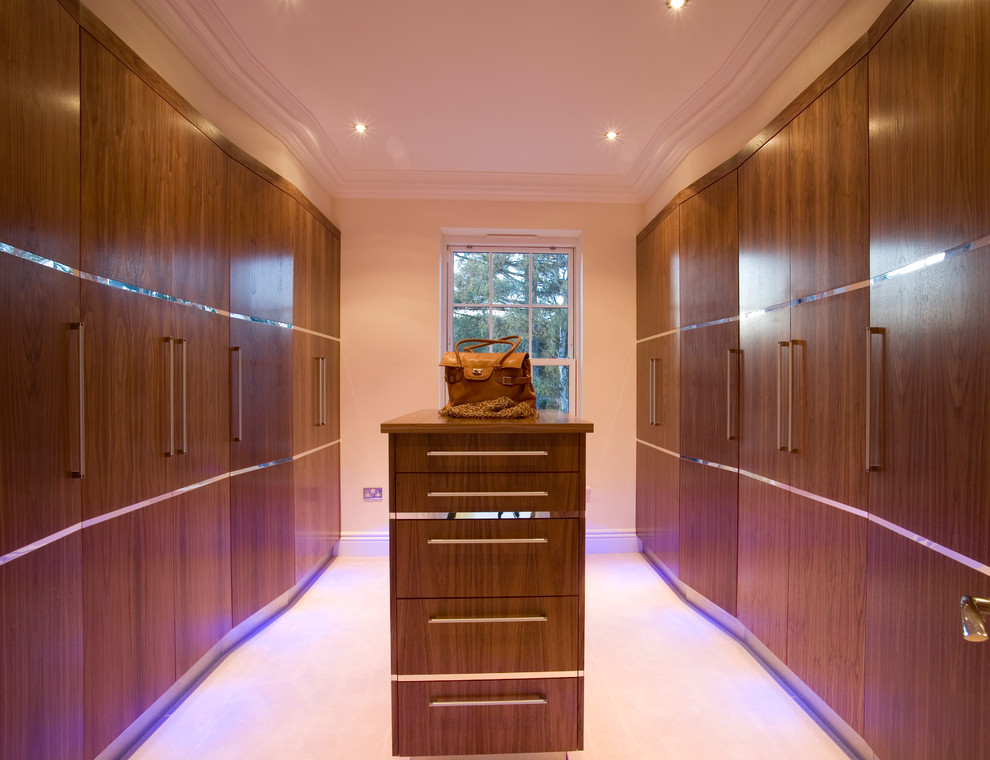 This is an example of a contemporary storage and wardrobe in Sussex with beige floor.
