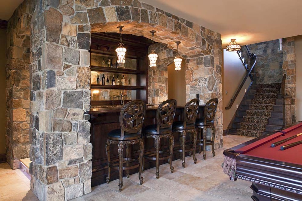 This is an example of a traditional home bar in Minneapolis with travertine floors and beige floor.