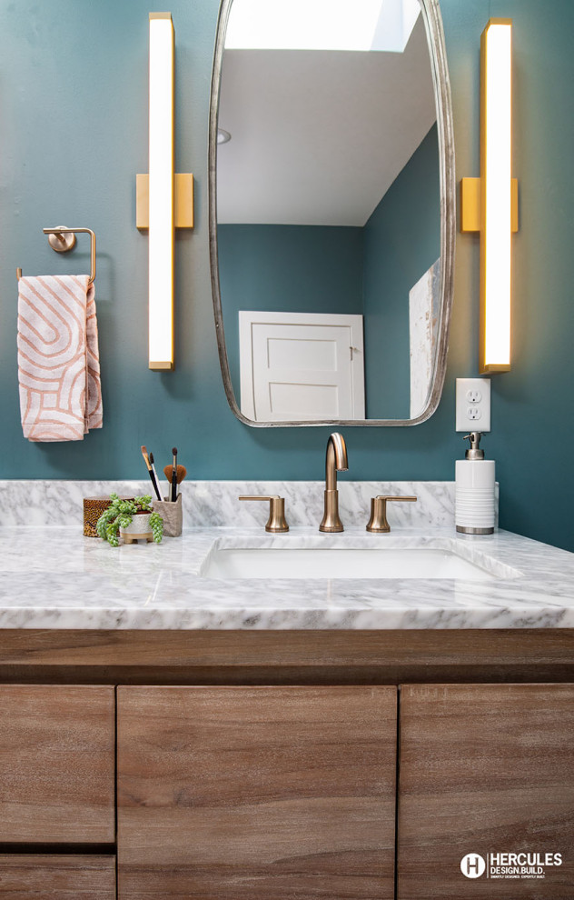 Design ideas for a mid-sized midcentury master bathroom in St Louis with flat-panel cabinets, medium wood cabinets, blue walls, an undermount sink, marble benchtops, grey benchtops, a double vanity, a freestanding vanity and vaulted.