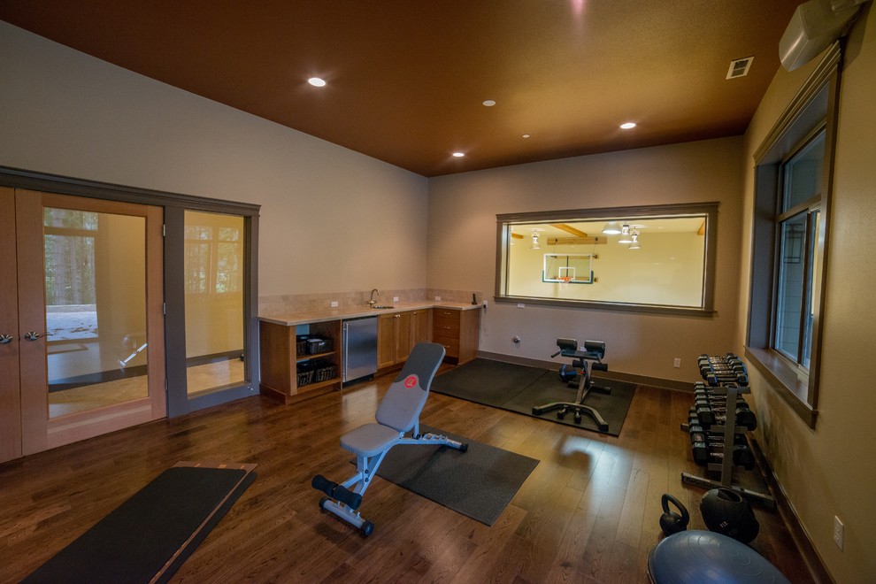 This is an example of an arts and crafts home gym in Seattle with dark hardwood floors.