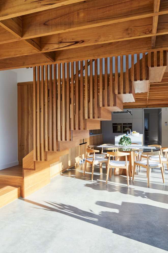 Photo of a mid-sized modern wood l-shaped staircase in Melbourne with wood risers and wood railing.