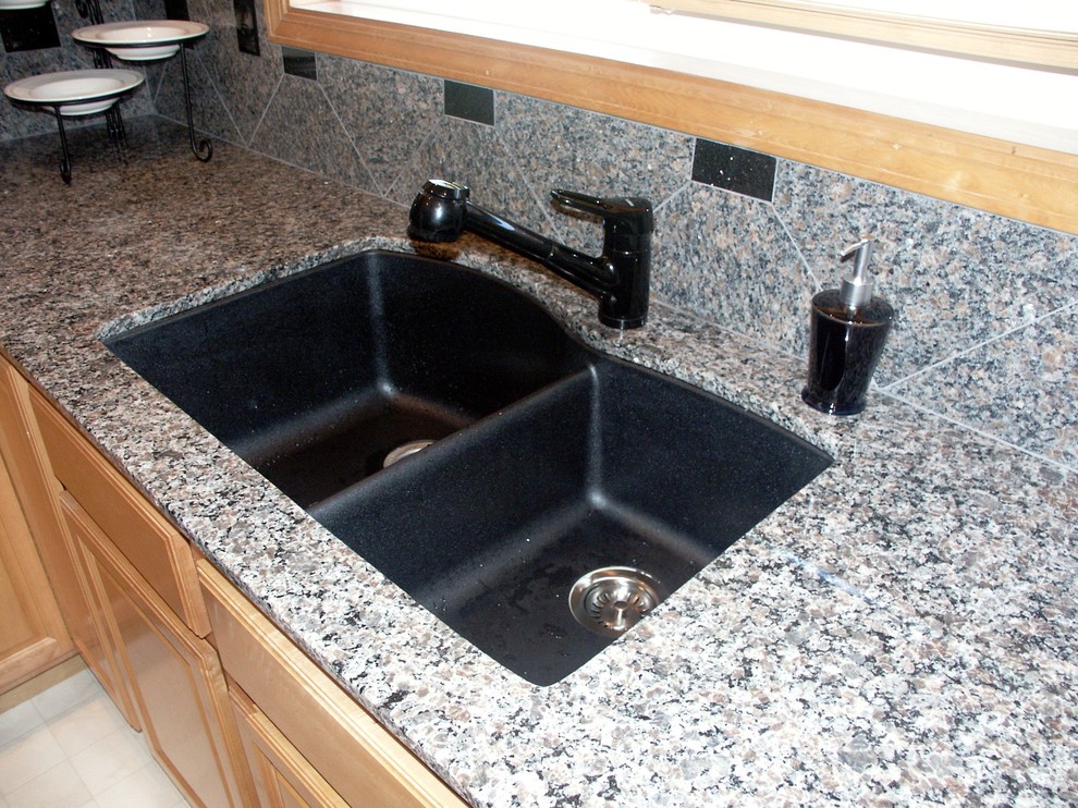 Transitional kitchen photo in Seattle with an undermount sink, granite countertops and stone tile backsplash