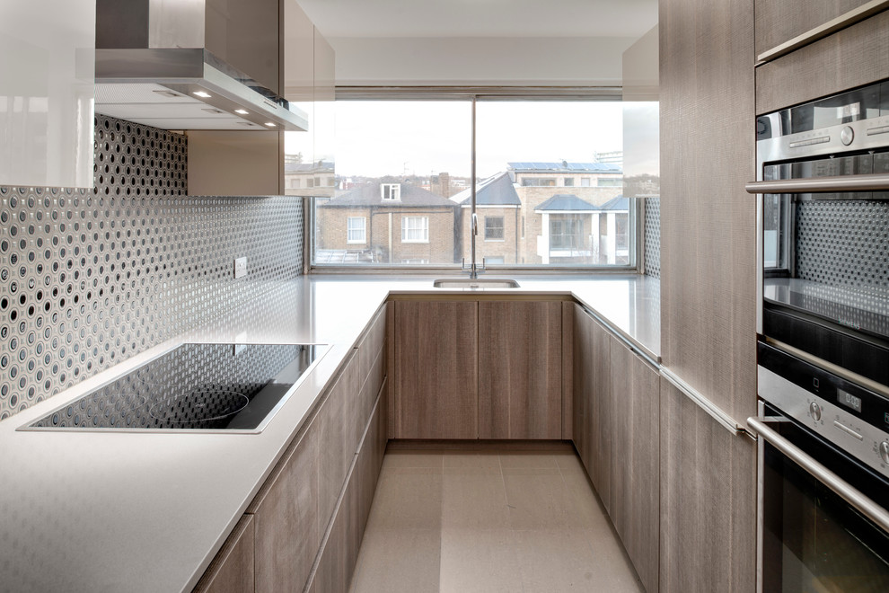Design ideas for a small contemporary u-shaped separate kitchen in London with flat-panel cabinets, medium wood cabinets, quartz benchtops, grey splashback, ceramic splashback, stainless steel appliances, ceramic floors and no island.