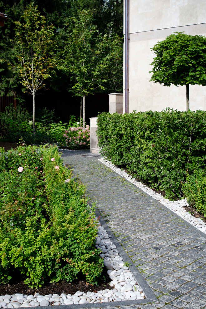 Photo of a traditional formal garden for summer in Moscow with a garden path.