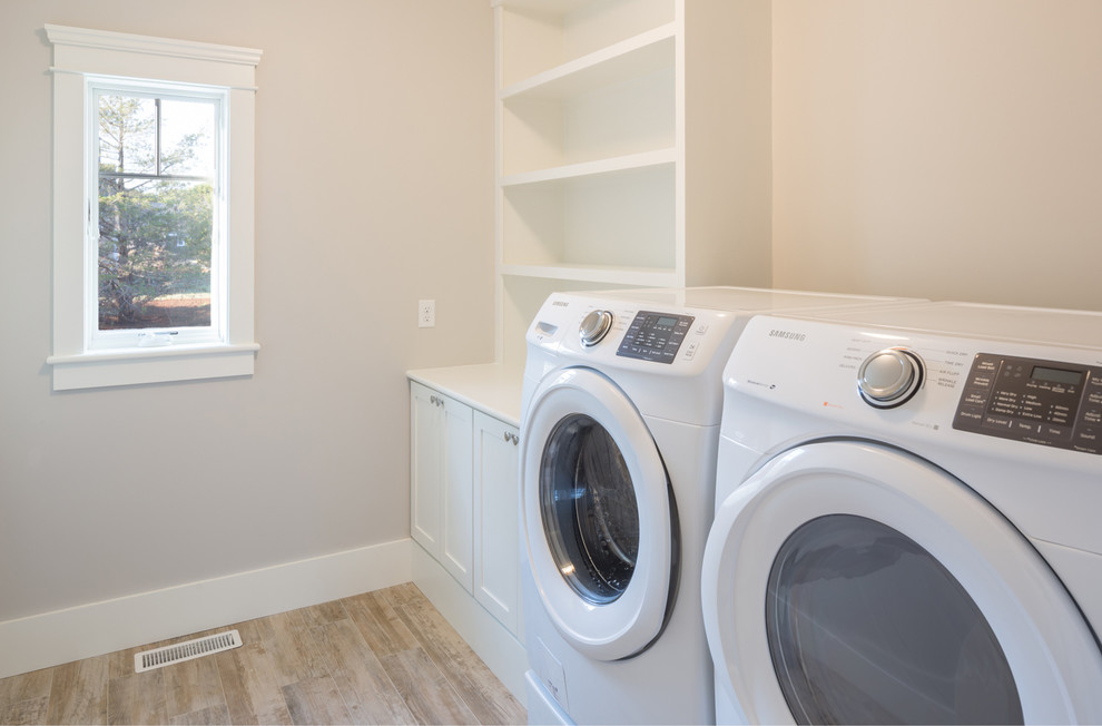 Design ideas for a mid-sized traditional dedicated laundry room in Boston with open cabinets, white cabinets, wood benchtops, beige walls and a side-by-side washer and dryer.