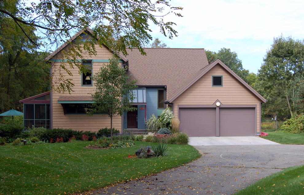 This is an example of a small transitional two-storey brown exterior in Grand Rapids with wood siding and a gable roof.