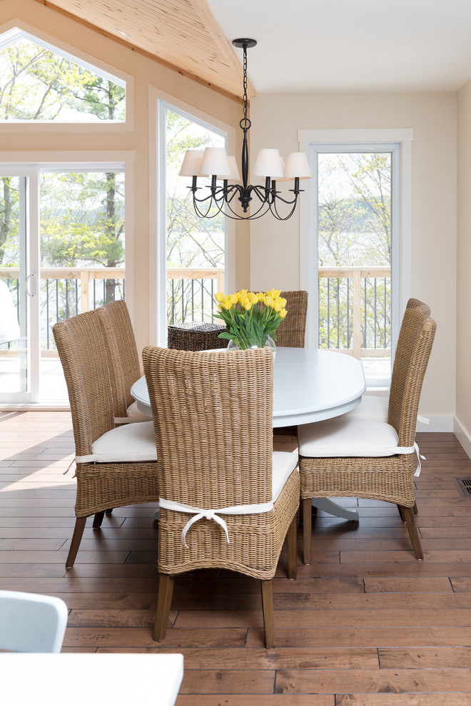 Design ideas for a beach style dining room in Ottawa with beige walls and dark hardwood floors.