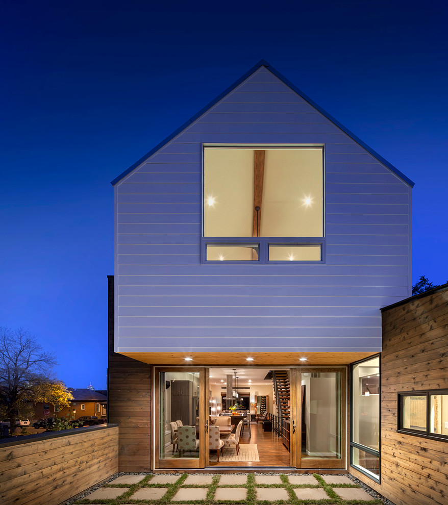 This is an example of a contemporary two-storey exterior in Denver with wood siding.