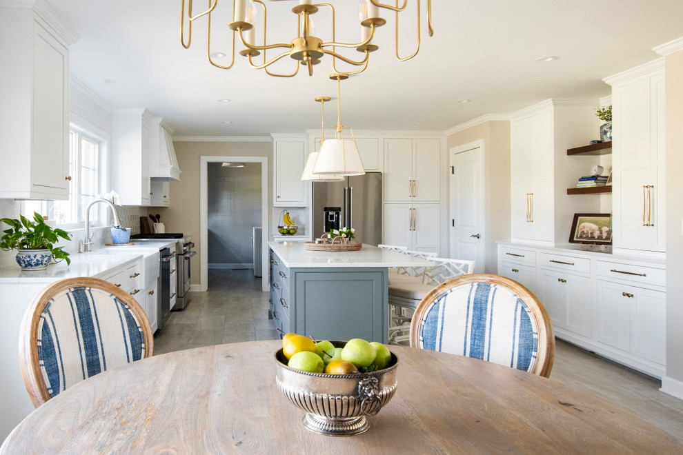 Inspiration for a large traditional u-shaped eat-in kitchen in Nashville with a farmhouse sink, beaded inset cabinets, white cabinets, quartz benchtops, white splashback, ceramic splashback, stainless steel appliances, porcelain floors, with island, beige floor and yellow benchtop.