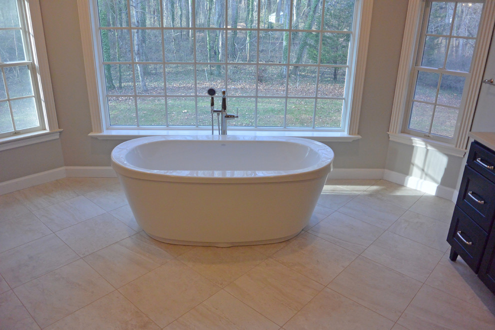Inspiration for a large transitional master bathroom in Baltimore with shaker cabinets, dark wood cabinets, a freestanding tub, an alcove shower, a two-piece toilet, beige walls, ceramic floors, an undermount sink, engineered quartz benchtops, beige floor, a hinged shower door and beige benchtops.