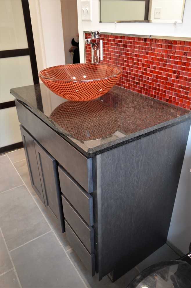This is an example of a mid-sized contemporary 3/4 bathroom in Chicago with shaker cabinets, grey cabinets, red tile, glass tile, white walls, a vessel sink, granite benchtops and black benchtops.