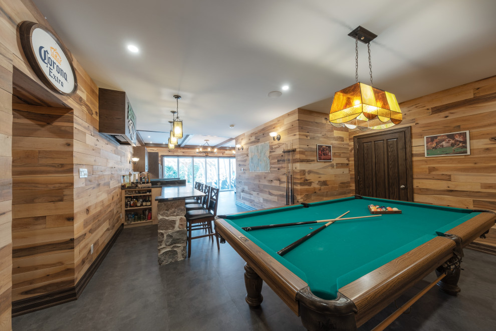 Basement - large rustic walk-out vinyl floor, gray floor, exposed beam and wood wall basement idea with a bar, multicolored walls, a standard fireplace and a stone fireplace