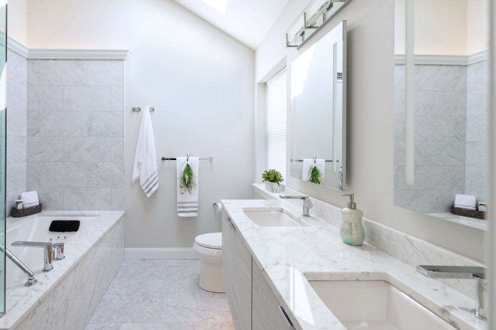 Inspiration for a contemporary master bathroom in Philadelphia with flat-panel cabinets, light wood cabinets, marble, white walls, marble floors, an undermount sink and grey floor.