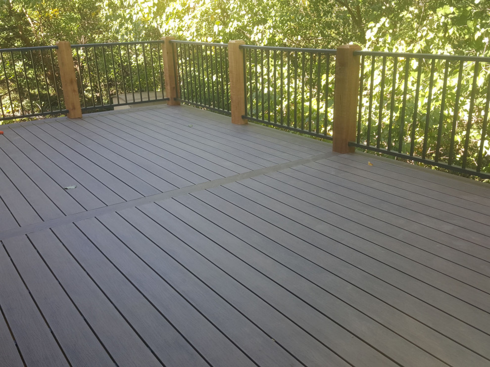 This is an example of a backyard deck in Omaha with metal railing.